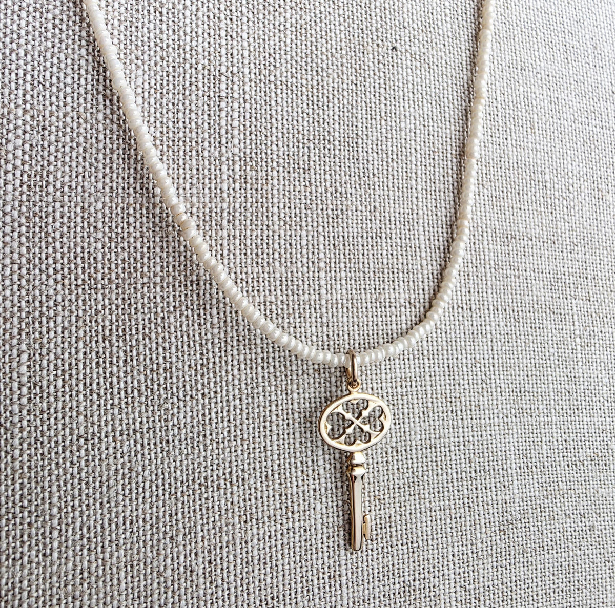 Gold Bronze Skeleton Key Pendant Necklace, Pearly Ivory Glass Seed Bead Chain, 14K Gold Filled Clasp