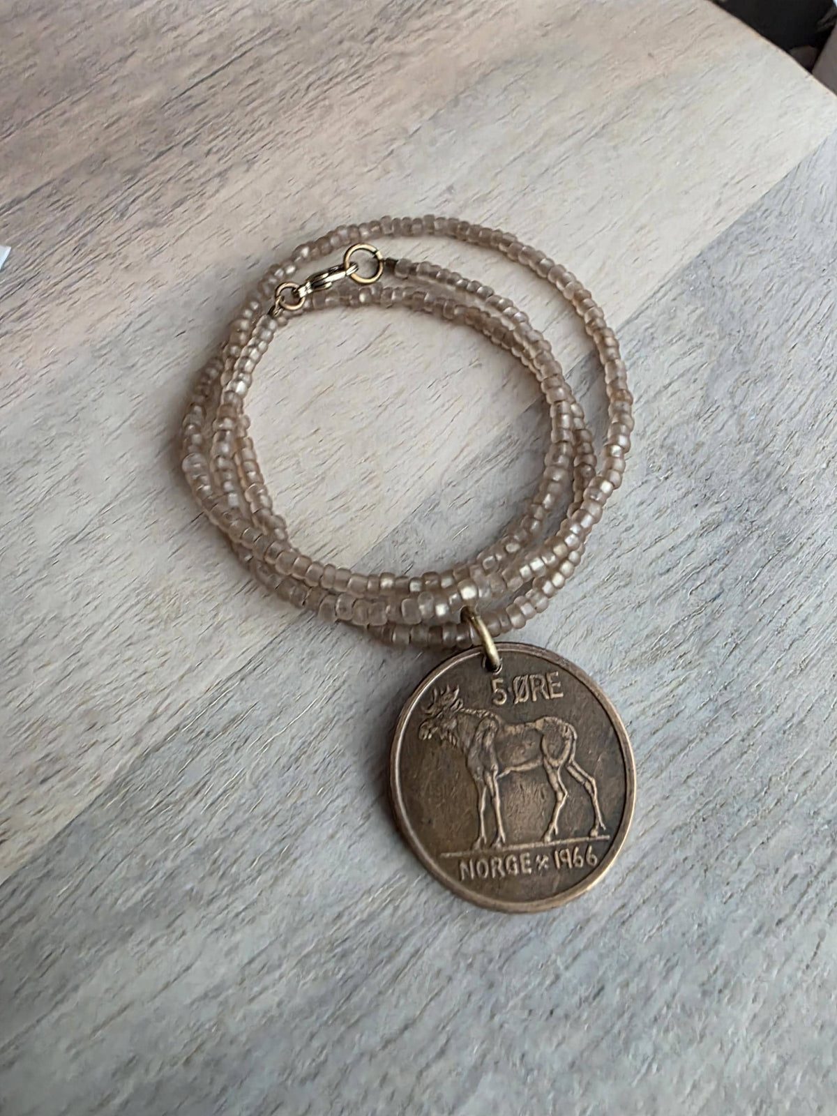 1966 Norge Norway Moose Coin Necklace, 5 Ore, Frosted Light Brown Glass Seed Bead Chain, Brass Lobster Claw Clasp, Made in USA