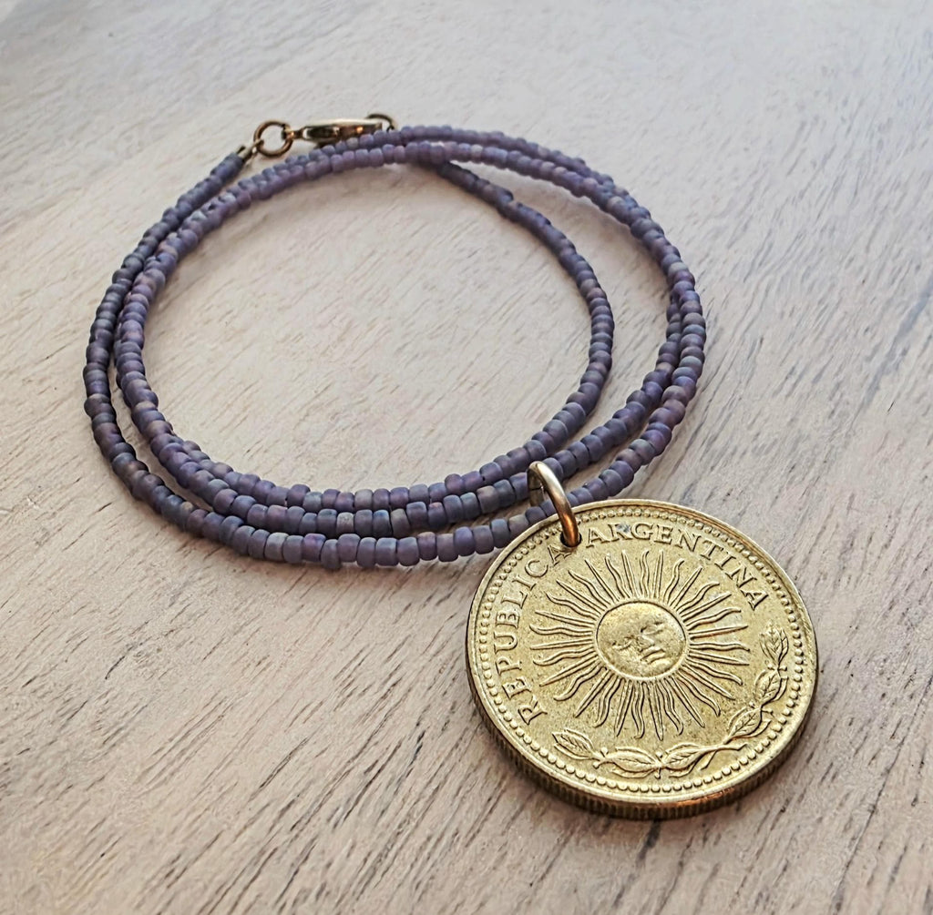 1978 Argentina Gold Sun Coin Necklace, Matte Purple Glass Seed Bead Chain, Solid Brass Clasp, Gift Boxed, Made in USA by E. Ria Designs