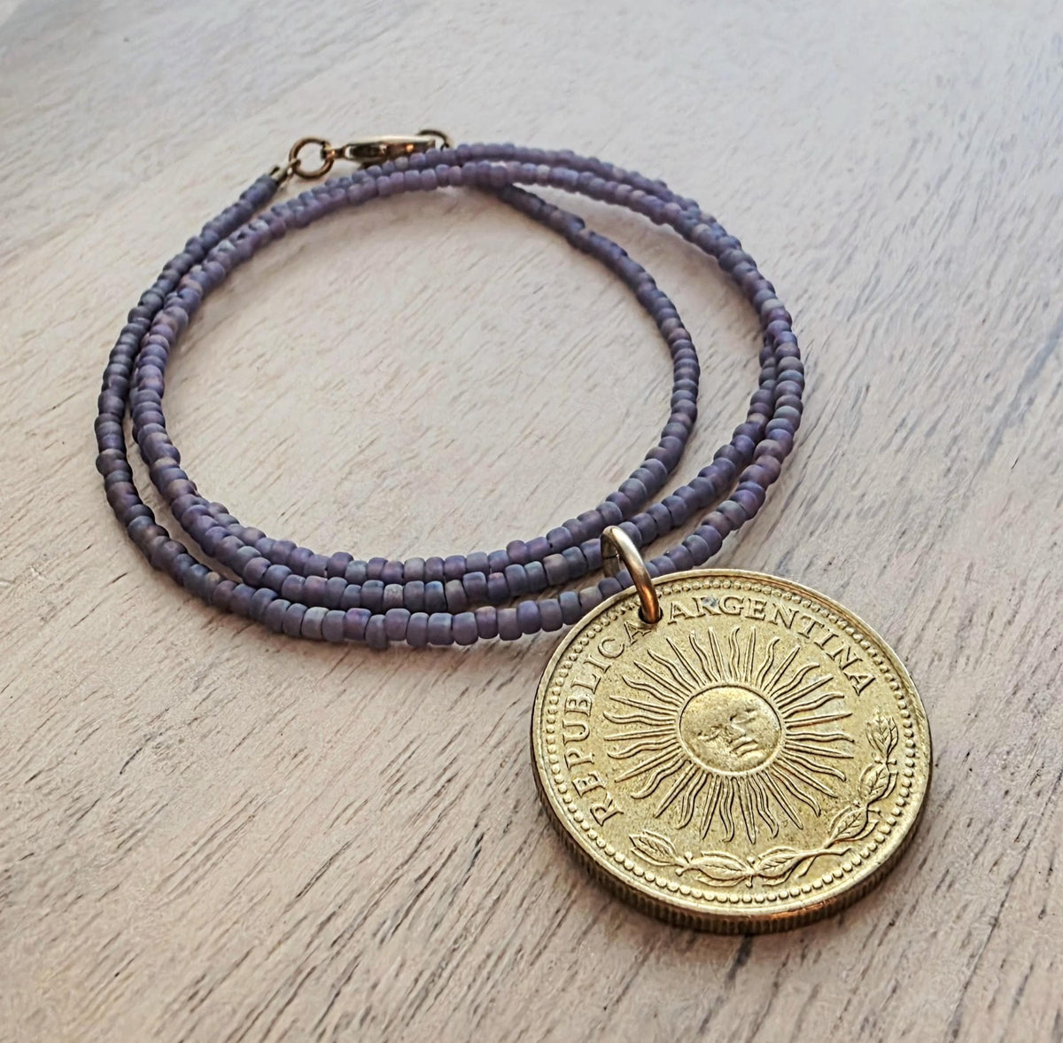 1978 Argentina Gold Sun Coin Necklace, Matte Purple Glass Seed Bead Chain, Solid Brass Clasp, Gift Boxed, Made in USA by E. Ria Designs
